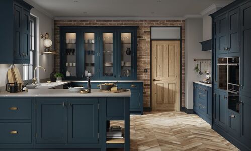 A modern Shaker kitchen with blue cabinets and a wood floor