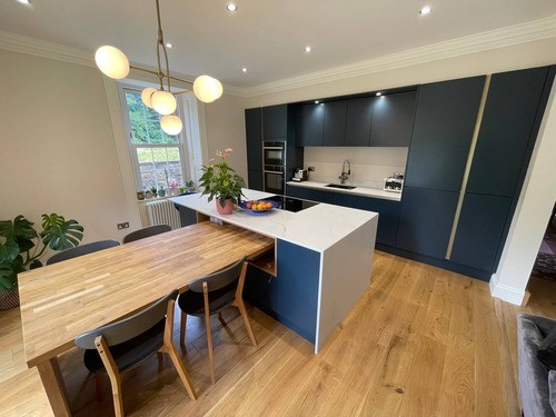 A kitchen with a pink island