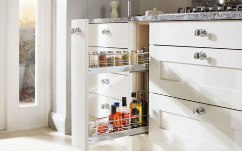 Pull-out spice and condiment storage racks in white kitchen cabinet