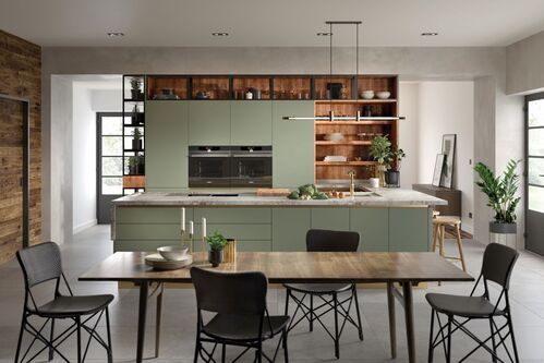 Contemporary kitchen with sage green cabinets and dining area