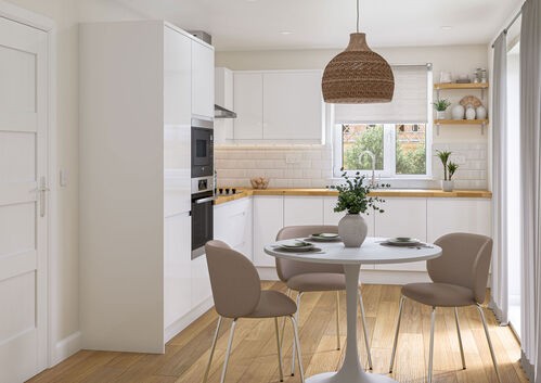 White kitchen with wooden counters, round dining table, and woven pendant light