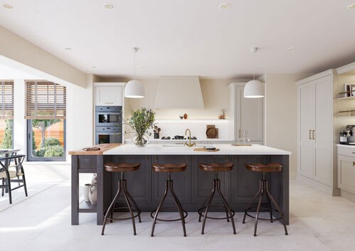 White kitchen with grey island and industrial-style bar stools