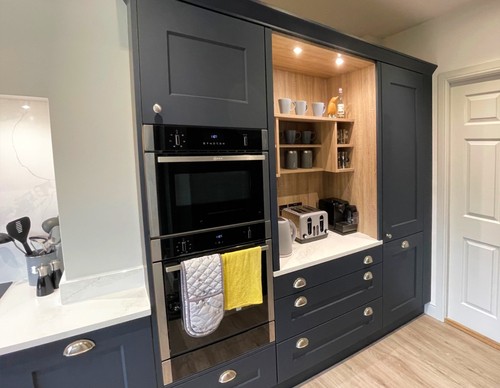 Built-in white wardrobe and storage solutions in modern bedroom