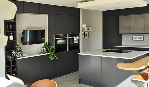 Compact utility space with integrated washer, dryer, and tall cabinets