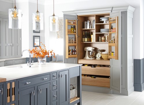 Shaker-style double-door larder with oak shelving and appliances