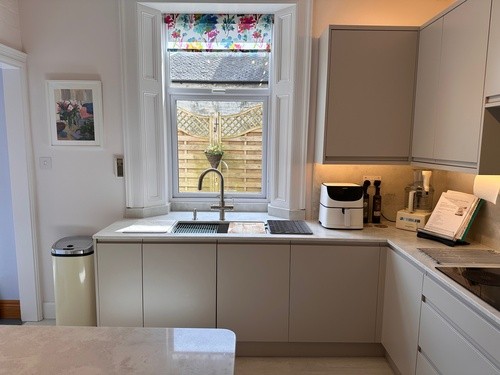 cabinets paired with cloud quartz worktops, neff appliances, and large island in modern open-plan space