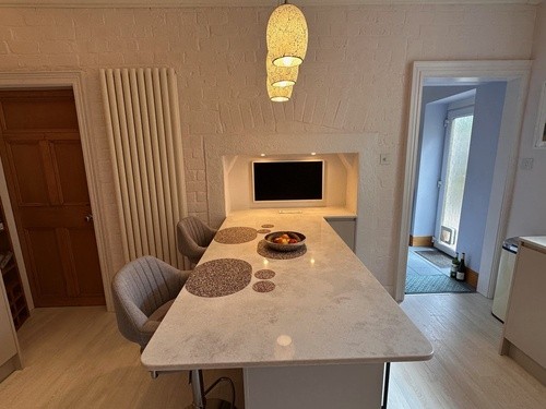 modern fitted kitchen with cloud quartz worktops and sleek island design in open-plan layout