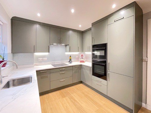 modern green kitchen with quartz worktop