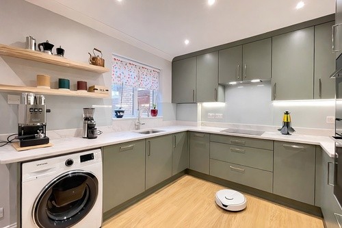 Modern kitchen with espresso and robot hoover