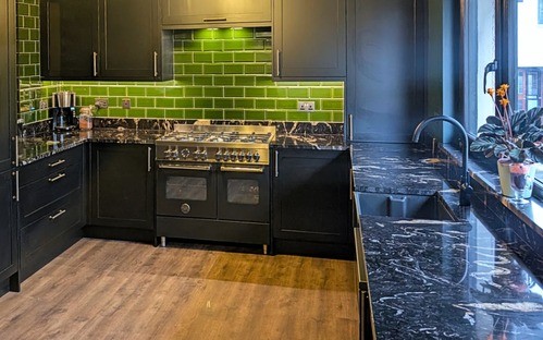 black worktop in a dark kitchen