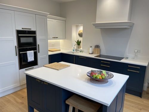 A shaker kitchen with slim frame, in navy blue and pale grey.