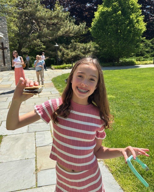 A young person enjoying a s’more outside