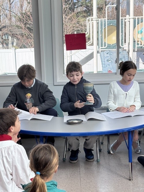 Young people sharing a lesson around a table