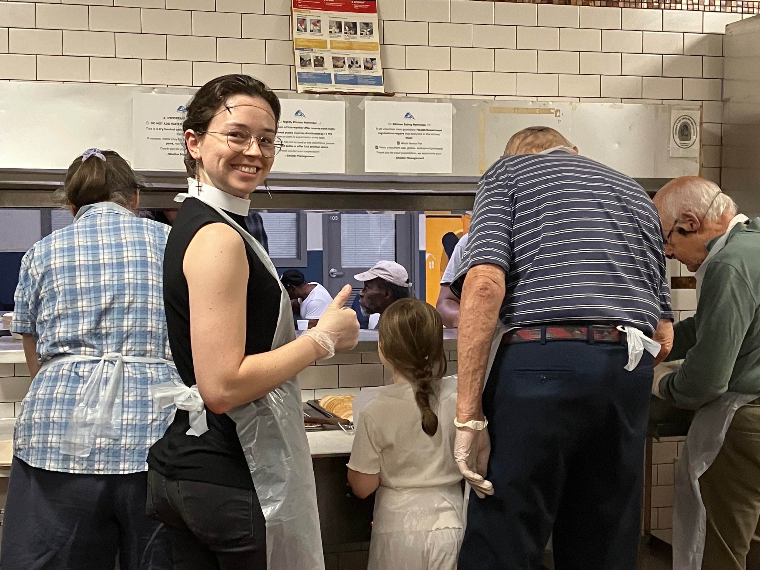 St. Barnabas volunteers preparing and serving a meal at Pacific House