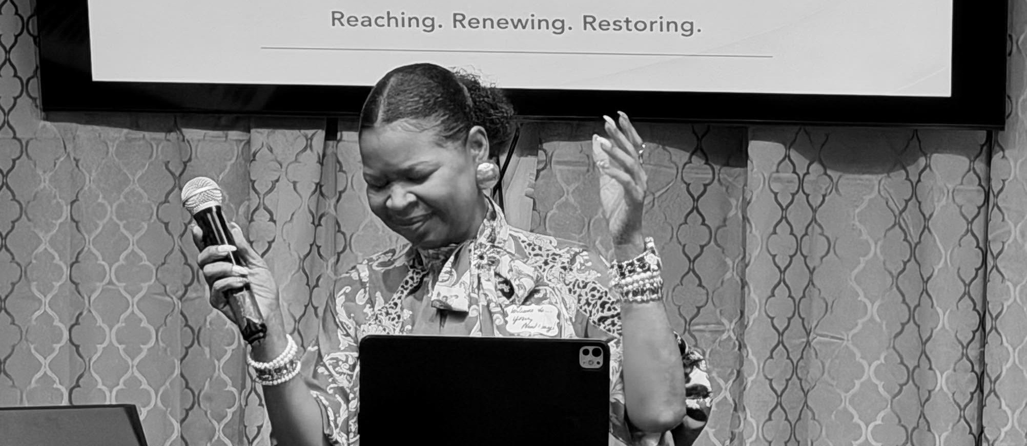 Worship leader welcoming the congregation at New Day Kingdom Ministries