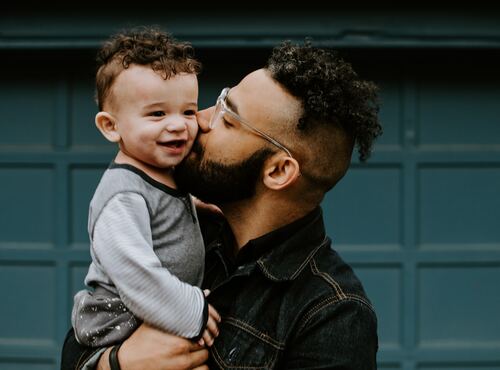 Clean Group, image of a male holding and kissing the cheek of a small toddler boy.