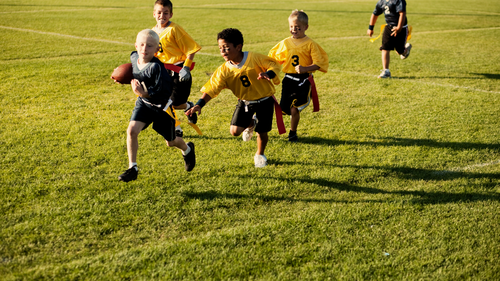 Image of children playing flag football.