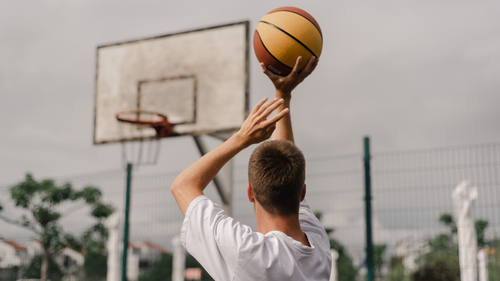 Image of a youth shooting a basketball.