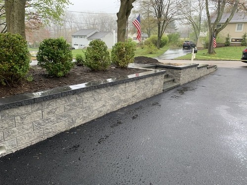 Custom paver courtyard with fire pit, seating walls, and gazebo lounge in Pompton Lakes NJ