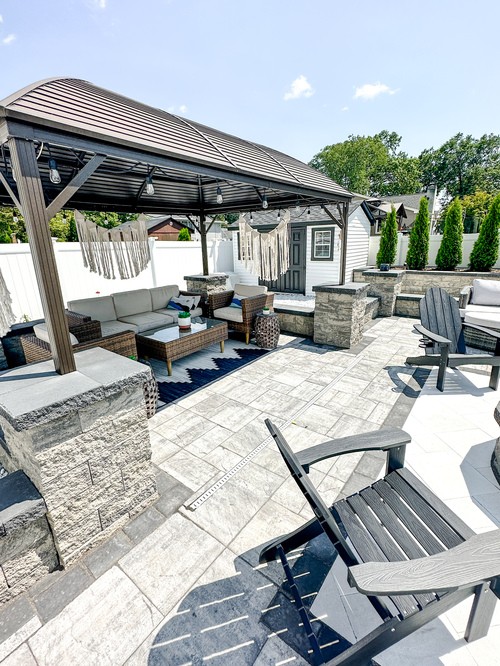 Covered paver seating area beside a pool in Pompton Lakes, NJ