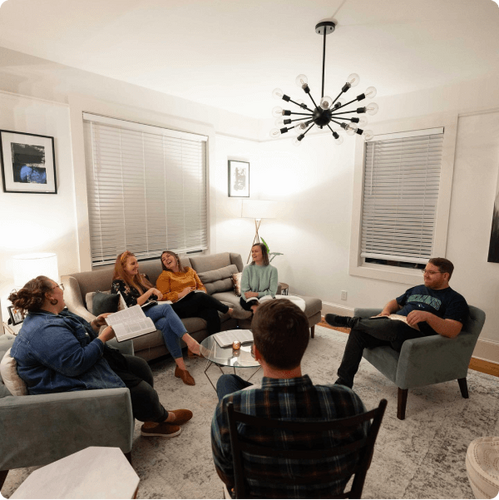 small group having bible study in apartment 