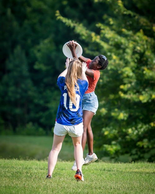 Impact Youth group girls playing frisbee 