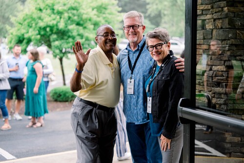 Impact Church Dream Team members welcoming guests at the church entrance before a worship experience.