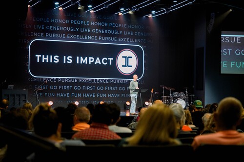 A pastor preaching during a worship service at Impact Church as the congregation listens.