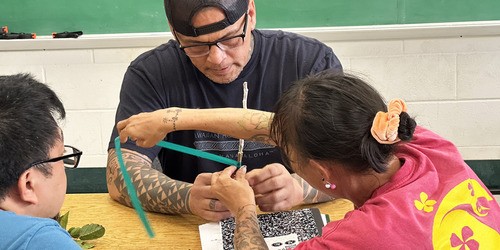man and woman grafting a plant