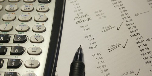 calculator pen and financial spreadsheet