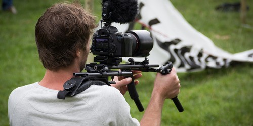 man operating a video camera
