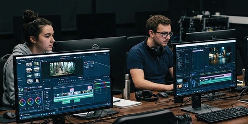 female and male working on computers