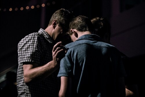 Men praying together
