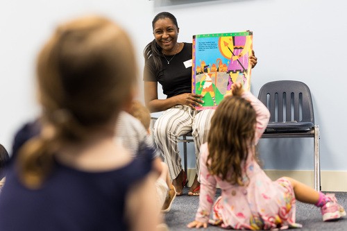 Child drawing with markers at a table