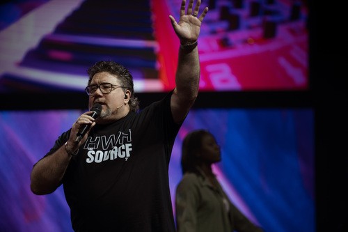 Pastor Michael on the platform with the Praise Team
