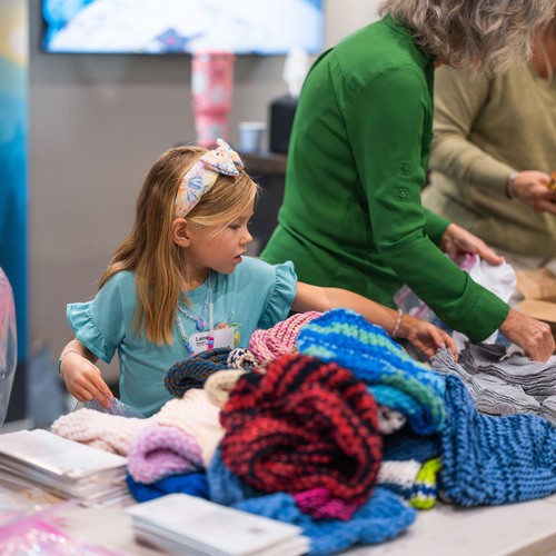 Volunteers sorting blessing bags with handmade blankets