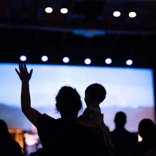 Worshippers with raised hands at a church service