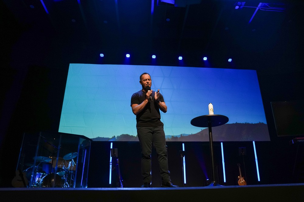 The pastor speaking on stage at Christ Center