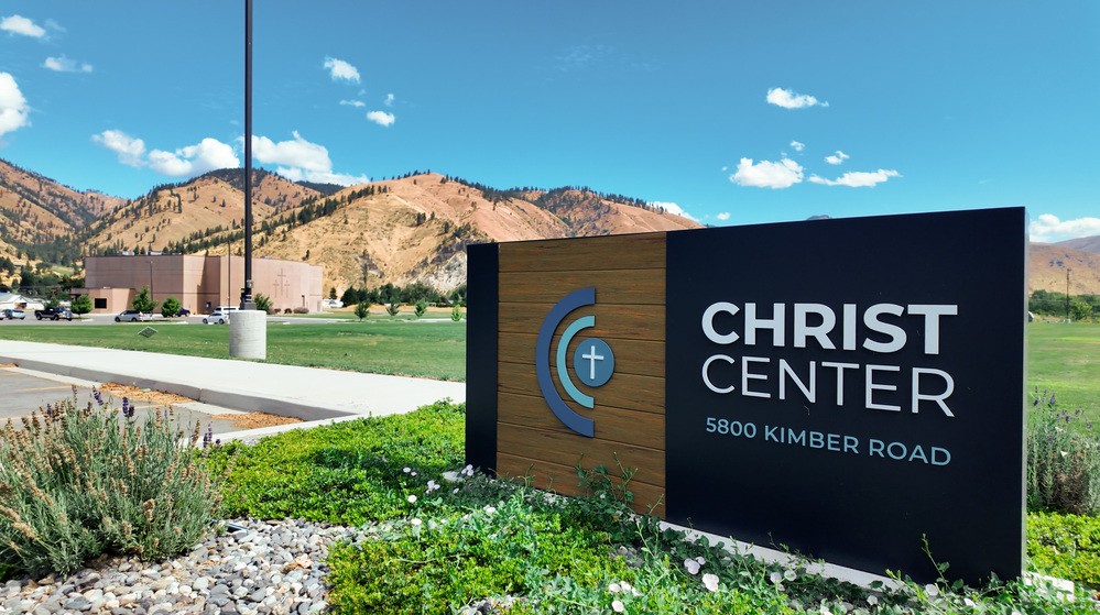The Christ Center sign at 5800 Kimber Road with the Cashmere hills behind