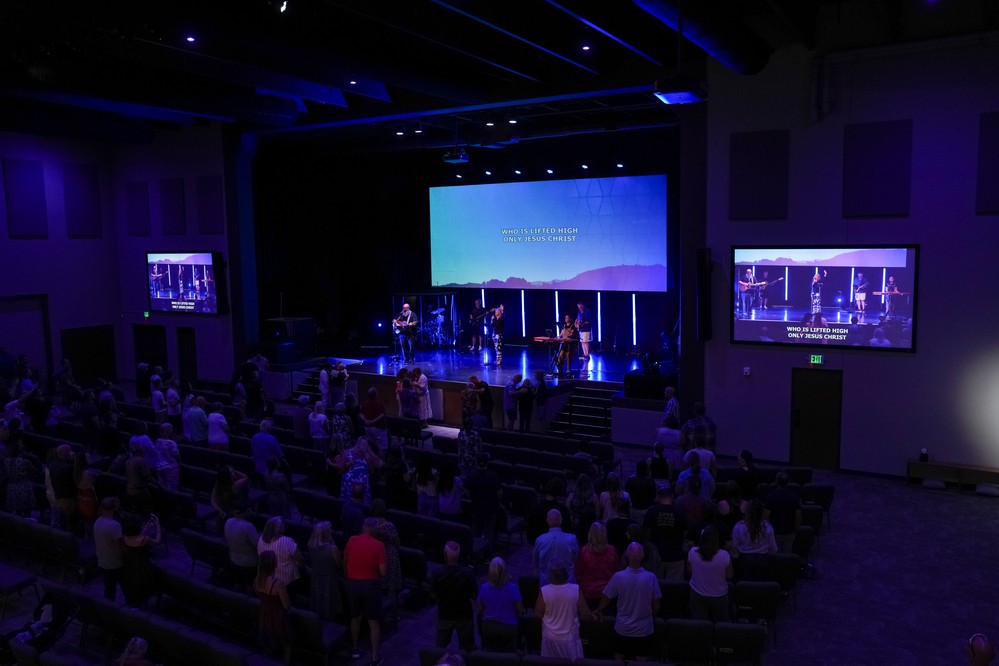 The Christ Center congregation standing in worship during a Sunday service
