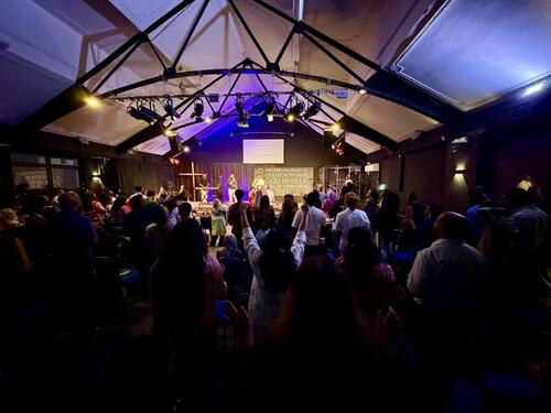 Hands raised in worship during the River revival