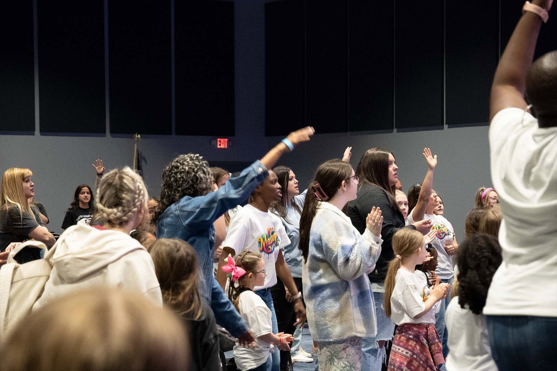 Girls worshiping with leaders