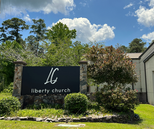 Liberty Church, one of the best churches in Havelock, NC, front sign with plants around it.