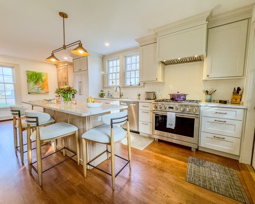 Modern kitchen featuring a white subway tile backsplash, sleek cabinetry, stainless steel appliances, and granite countertops with subway tile backsplash