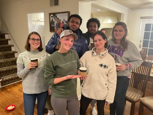 Group of young adults at indoor party during wintertime