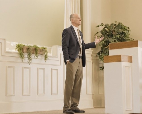 Pastor preaching beside the pulpit at Heritage Baptist Church