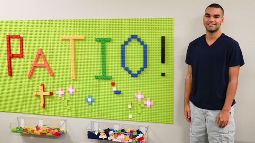Young Man with Special Needs by Lego Wall 