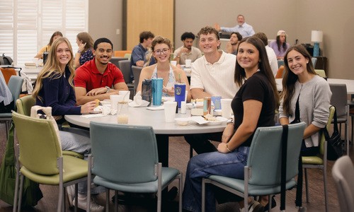 UHBC college students gathered around a table at a University Ministry event in Stillwater, Oklahoma