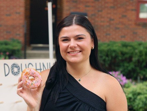UHBC college student holding a donut at a University Ministry event in Stillwater, Oklahoma