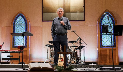 John Talley speaking on stage at University Heights Baptist Church for Fellowship of Christian Athletes Sunday in Stillwater, Oklahoma